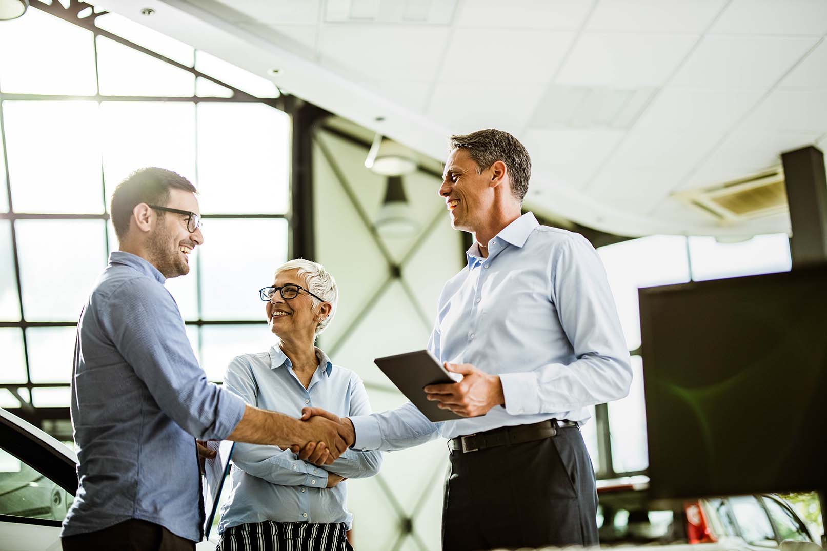 Businesspeople shaking hands after making a deal.